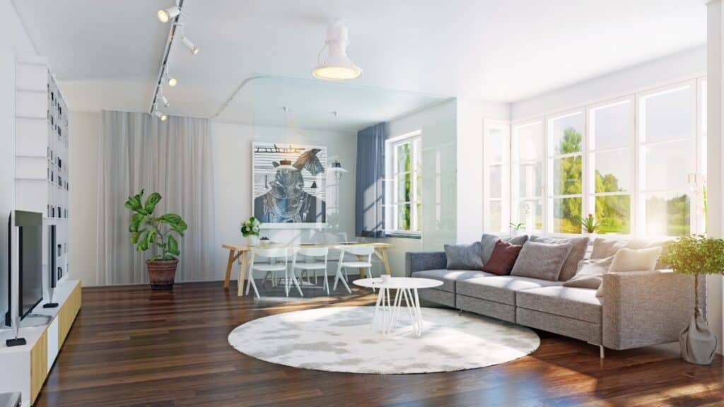 Maid service refreshing a sunlit living room with polished floors and dust-free surfaces.